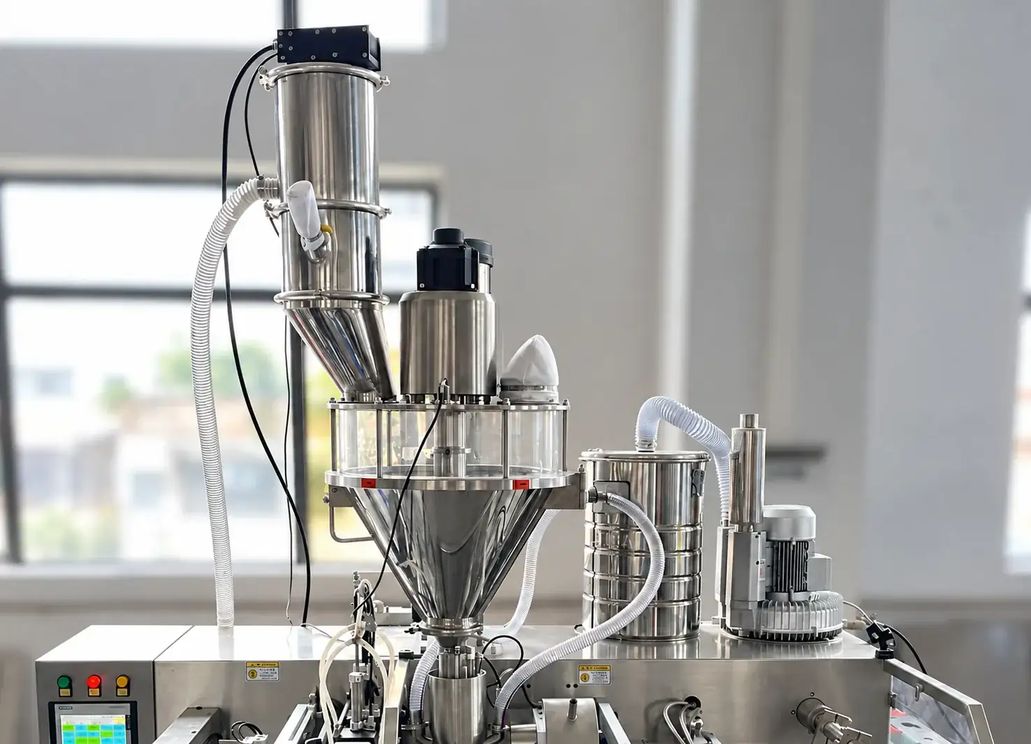 Powder vacuum feeder with auger dosing unit and dust collection equipment